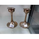 A PAIR OF SILVER HALLMARKED CANDLESTICKS.