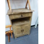 AN ANTIQUE OAK BEDSIDE CABINET.