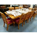 A LARGE MODERN DINING TABLE AND EIGHT MATCHING CHAIRS.