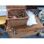 A LARGE WICKER BASKET, A SMALL WICKER BASKET, PLATEDWARE AND VARIOUS LINENS.