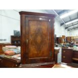 AN ANTIQUE WALNUT VENEERED CORNER CABINET.