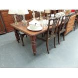 A VICTORIAN MAHOGANY DINING TABLE.