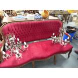 A SHOWFRAME RED VELVET THREE SEATER SETTEE.