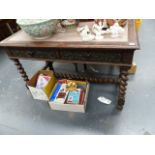 AN ANTIQUE OAK TWO DRAWER WRITING TABLE.