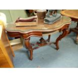 A CARVED MAHOGANY CENTRE TABLE.