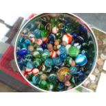 A TIN OF MARBLES.