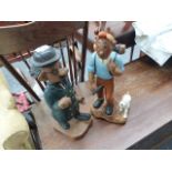 A CARVED WOOD FIGURE ON TIN TIN AND COMPANION.