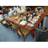 A VICTORIAN MAHOGANY WIND OUT EXTENDING DINING TABLE.