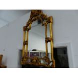 A GILT FRAMED MIRROR.