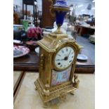 A GILT BRASS MANTLE CLOCK.