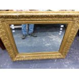 AN ANTIQUE GILT FRAMED MIRROR.