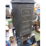 AN ANTIQUE CARVED CORNER CABINET AND A MAHOGANY OCCASIONAL TABLE.