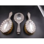 A TIFFANY AND CO STERLING THREE PART VANITY SET, HAND CHASED WITH REPOUSSE DECORATION AND A