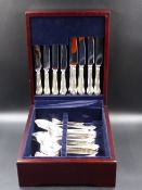 A SILVER HALLMARKED CASED CANTEEN OF CUTLERY OF FIDDLE SHELL AND SCROLL DESIGN VARIOUSLY DATED