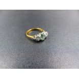 AN 18ct YELLOW GOLD AQUAMARINE AND DIAMOND THREE STONE RING. THE CENTRAL OVAL AQUAMARINE IS