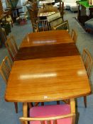 A GORDON RUSSELL TEAK AND ROSEWOOD DINING TABLE TOGETHER WITH A SET OF SIX DINING CHAIRS INCLUDING