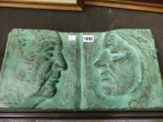 NEMON. 20th.C.SCHOOL. A BRONZE PLAQUE WITH TWO OPPOSING FACIAL PROFILES, SIGNED. 23 x 47cms.