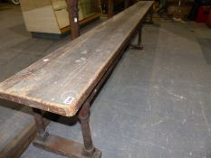 A 19th.C.PINE FORM BENCH ON SIX SPLAY TURNED LEGS. L.340cms.