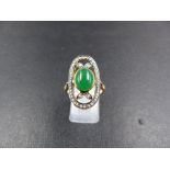 A DIAMOND AND CABOCHON OVAL GEMSTONE ELONGATED RING, TESTS AS GOLD, FINGER SIZE O. WEIGHT 5grms.