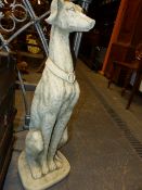 A PAIR OF COMPOSITE STONE GARDEN GATEPOST FIGURES OF SEATED DOGS. H.81cms.