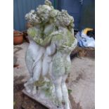 A COMPOSITE STONE GARDEN STATUE OF THE THREE GRACES. H.84cms TOGETHER WITH A PAIR OF PLINTHS AND TWO