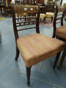 A SET OF SIX LATE GEORGIAN MAHOGANY AND BRASS INLAID DINING CHAIRS ON TURNED FORELEGS.