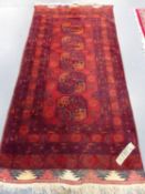 AN AFGHAN BOKHARA RUG. 218 x 107cms.