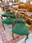 A SET OF SIX VICTORIAN ROSEWOOD BALLOON BACK SIDE CHAIRS WITH CARVED CENTRE RAIL BACKS, GREEN VELVET