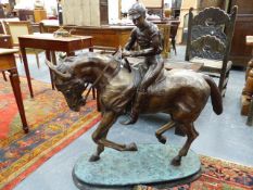 A LARGE IMPRESSIVE DECORATIVE BRONZE OF A JOCKEY ON A RACEHORSE. H.103 x W.100cms.