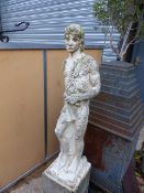 A COMPOSITE STONE GARDEN STATUE OF A STANDING CLASSICAL MALE FIGURE ON A PLINTH BASE. OVERLL H.