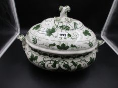 A MEISSEN TWO HANDLED SOUP TUREEN AND COVER DECORATED IN GREEN WITH VINES AND BACCHIC TROPHY