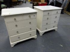 A PAIR OF BEDSIDE CHESTS OF TWO SHORT AND THREE LONG DRAWERS WITH RING HANDLES AND STANDING ON