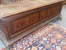 AN ITALIAN 18th.C.WALNUT AND INLAID CASSONNE WITH INLAID ARMORIAL PANEL RAISED ON PAW FEET. W.