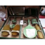 A GREEN GUILLOCHE ENAMEL AND SILVER HALLMARKED THIRTEEN PIECE FITTED TRAVEL DRESSING TABLE SET TO