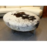 A 20th.C.LARGE OVAL STOOL WITH CHROME FRAME AND COW HIDE UPHOLSTERY. 110 x 82 x H.48cms.