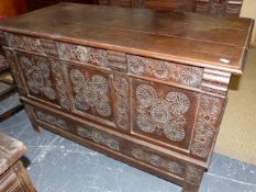 AN 18th.C.OAK MULE CHEST WITH PLANK TOP OVER WELL CARVED FRIEZE AND THREE PANELS WITH LONG DRAWER TO