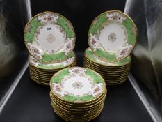 A COALPORT PART DINNER SERVICE, EACH PIECE WITH GILDED RIM, APPLE GREEN BAT SHAPED PANELS WITH