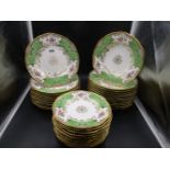 A COALPORT PART DINNER SERVICE, EACH PIECE WITH GILDED RIM, APPLE GREEN BAT SHAPED PANELS WITH