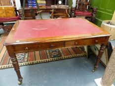 A VICTORIAN OAK LIBRARY TABLE WITH TWO FRIEZE DRAWERS ON TURNED LEGS WITH BRASS CASTORS, THE