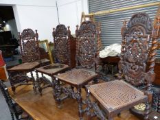 A SET OF EIGHT VICTORIAN CARVED OAK DINING CHAIRS WITH CANED BACK PANELS AND SEATS. TOGETHER WITH