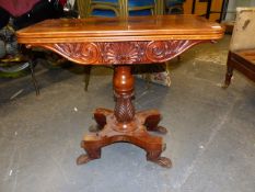 A 19th.C.COLONIAL MAHOGANY FOLD OVER CARD TABLE WITH CARVED FRIEZE, TURNED AND LEAF CARVED COLUMN