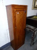 A BESPOKE OAK GUN CABINET COVER WITH PANEL DOOR. W.48 x H.134cms.