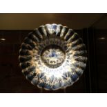 AN EARLY BLUE AND WHITE TIN GLAZED FLUTED BOWL, POSSIBLY FRANKFURT, PAINTED WITH FLOWERS AND