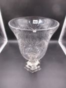 A CUT GLASS FOOTED VASE, THE BELL SHAPED BOWL ON FACETED STEM AND STEPPED HEXAGONAL FOOT. H.33cms.