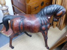 A LARGE LEATHER FIGURE OF A PRANCING HORSE. W.110 x H.96cms.