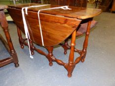A SOLID YEW WOOD COTTAGE GATELEG SUPPER TABLE ON TURNED LEGS AND STRETCHERS. W.118 x H.69cms.