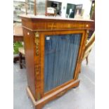 A VICTORIAN WALNUT AND INLAID PIER CABINET WITH GILT BRASS MOUNTS AND SINGLE GLAZED DOOR ENCLOSING