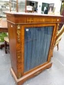 A VICTORIAN WALNUT AND INLAID PIER CABINET WITH GILT BRASS MOUNTS AND SINGLE GLAZED DOOR ENCLOSING