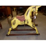 AN EARLY 20th.C.CARVED PINE ROCKING HORSE ON TRESTLE BASE. HOOF TO EAR. 76cms.