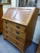 ALAN GRAINGER. ACORNMAN. A HAND MADE ENGLISH OAK FALL FRONT BUREAU OVER FIVE DRAWERS ON BRACKET